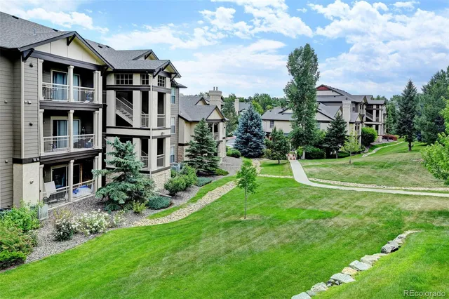 a view of a patio with dining table and chairs with wooden fence