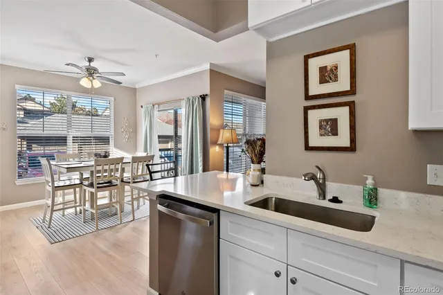 a kitchen with a table chairs and white cabinets