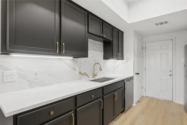 a spacious bathroom with a sink and mirror