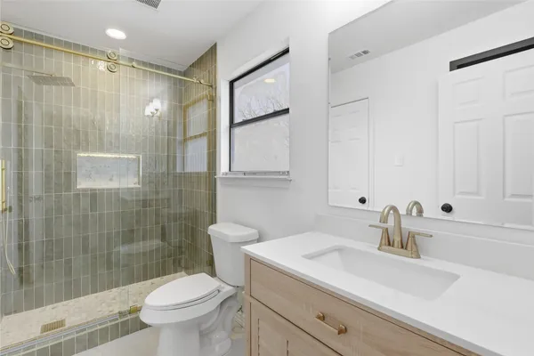 a bathroom with a sink toilet and shower