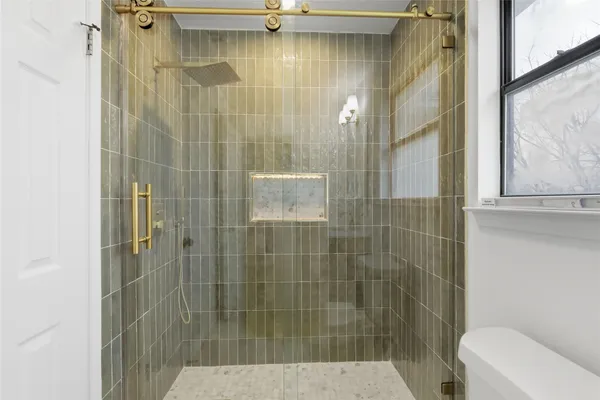 a bathroom with a shower and toilet
