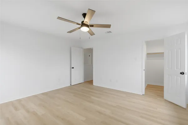 a view of an empty room with wooden floor