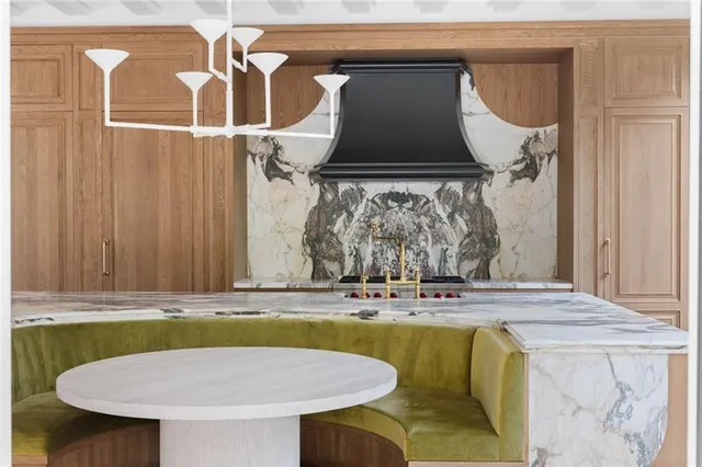 a bathroom with granite countertop a sink and a window