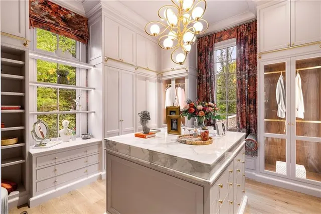a bathroom with a granite countertop sink a mirror and shower