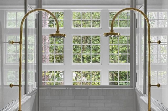 a view of a big house with a big yard plants and large trees