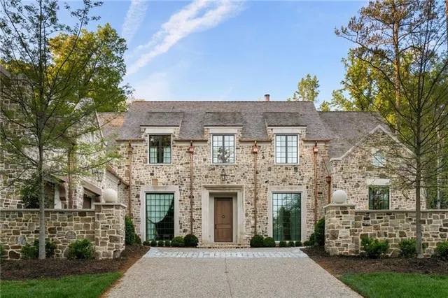 front view of a brick house with a yard