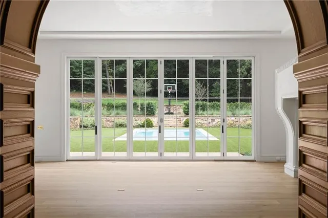 a view of an empty room with window and fireplace