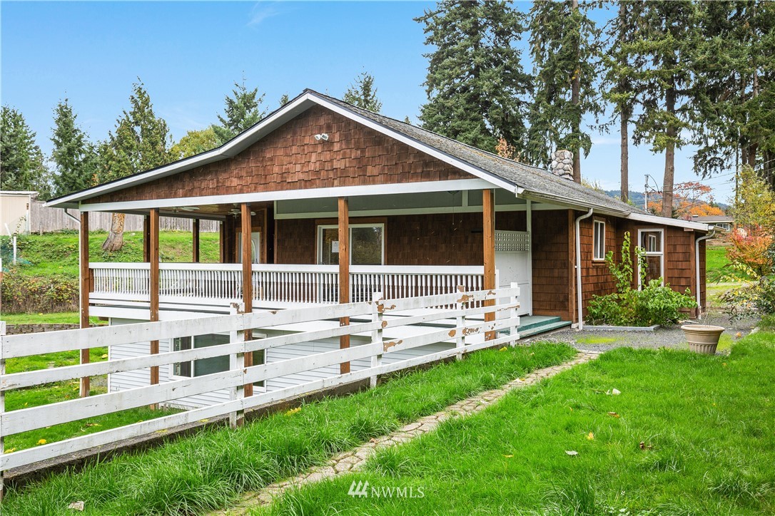a front view of a house with a yard and outdoor seating