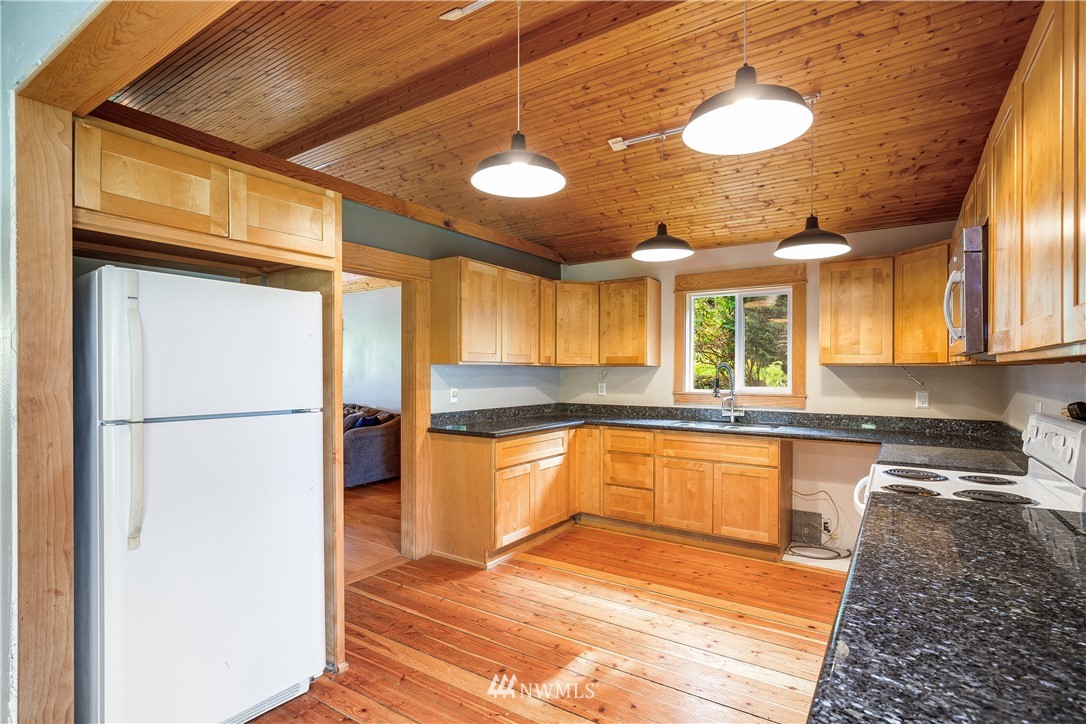 17510 Southeast 121st Place Renton, WA 98059 - Photo 15 of 40 a kitchen with stainless steel appliances granite countertop a refrigerator a oven and a sink with granite countertops