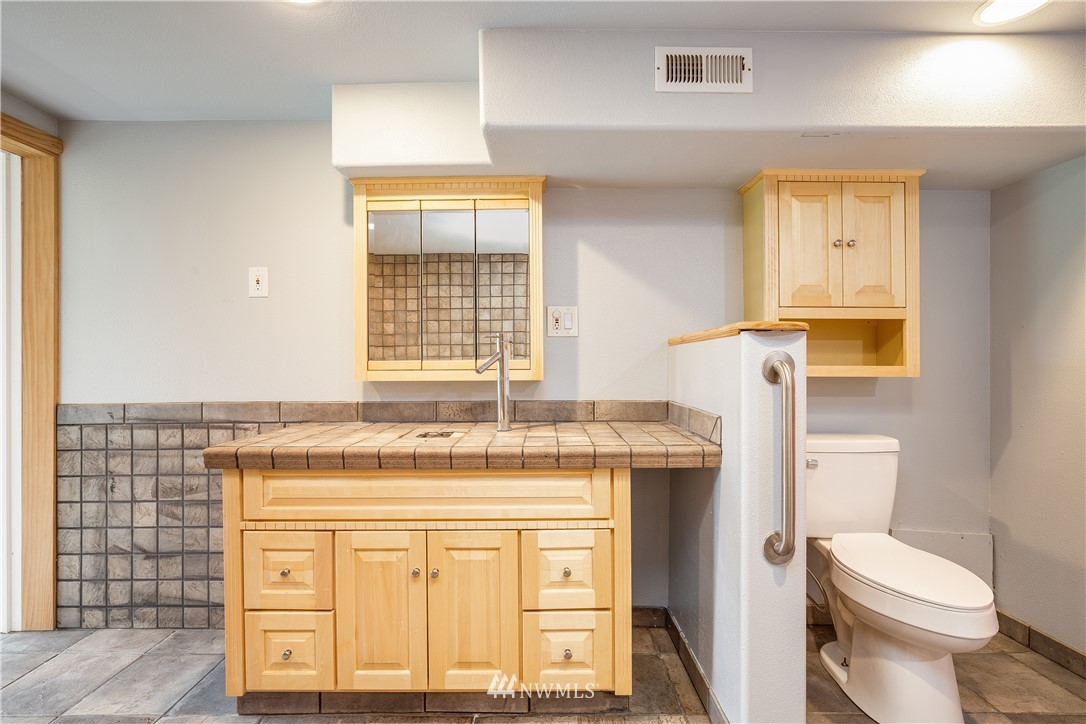 17510 Southeast 121st Place Renton, WA 98059 - Photo 27 of 40 a bathroom with a granite countertop toilet sink and mirror