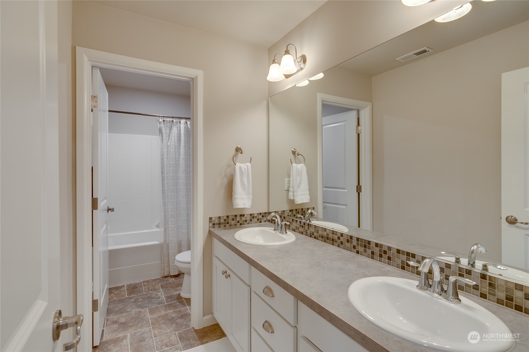 15932 Meridian Avenue South Bothell, WA 98012 - Photo 15 of 33 a bathroom with a sink double vanity and a mirror