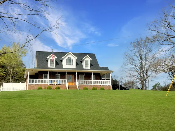 a view of a large building with a big yard and large trees