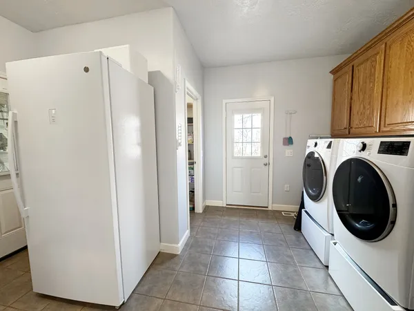 a view of staircase with lots of frames on wall and a ceiling fan