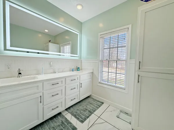 a bathroom with a shower and a sink