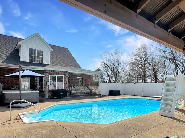 a view of outdoor kitchen with a sink and furniture