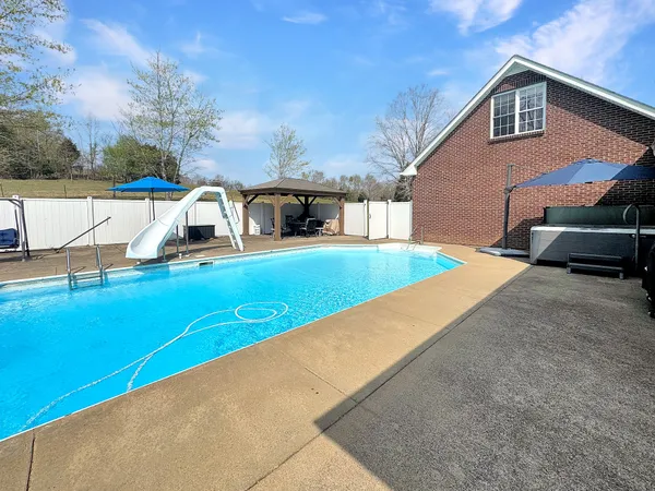 a view of a house with a yard and sitting area