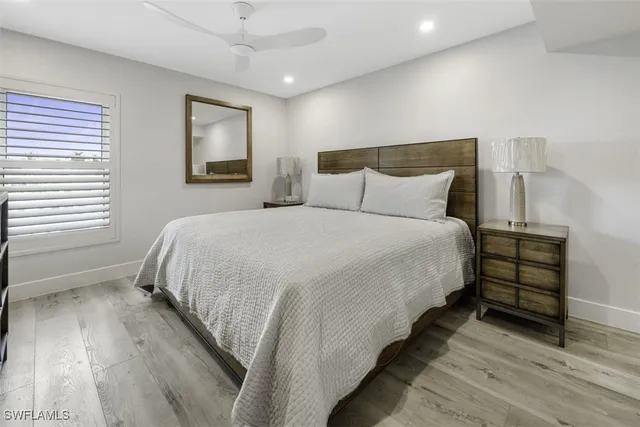 a bedroom with a bed and a night stand