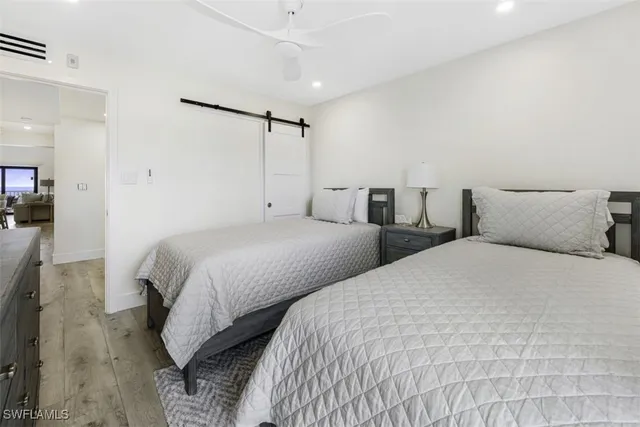 a bedroom with two beds and painted walls