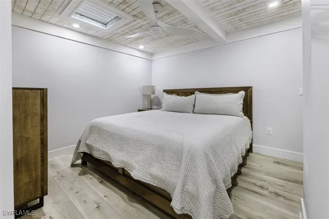 a bed room with a bed and a night stand