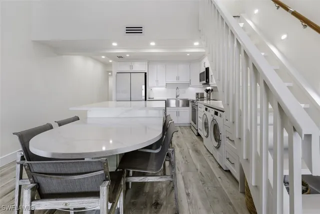 a dining room with furniture and wooden floor