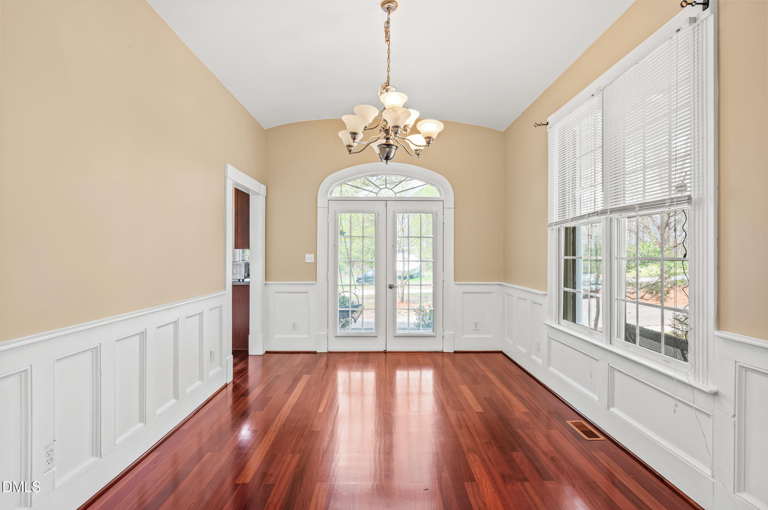 1957 Hilltop Road Raleigh, NC 27610 - Photo 5 of 46 a view of an empty room with wooden floor and a window