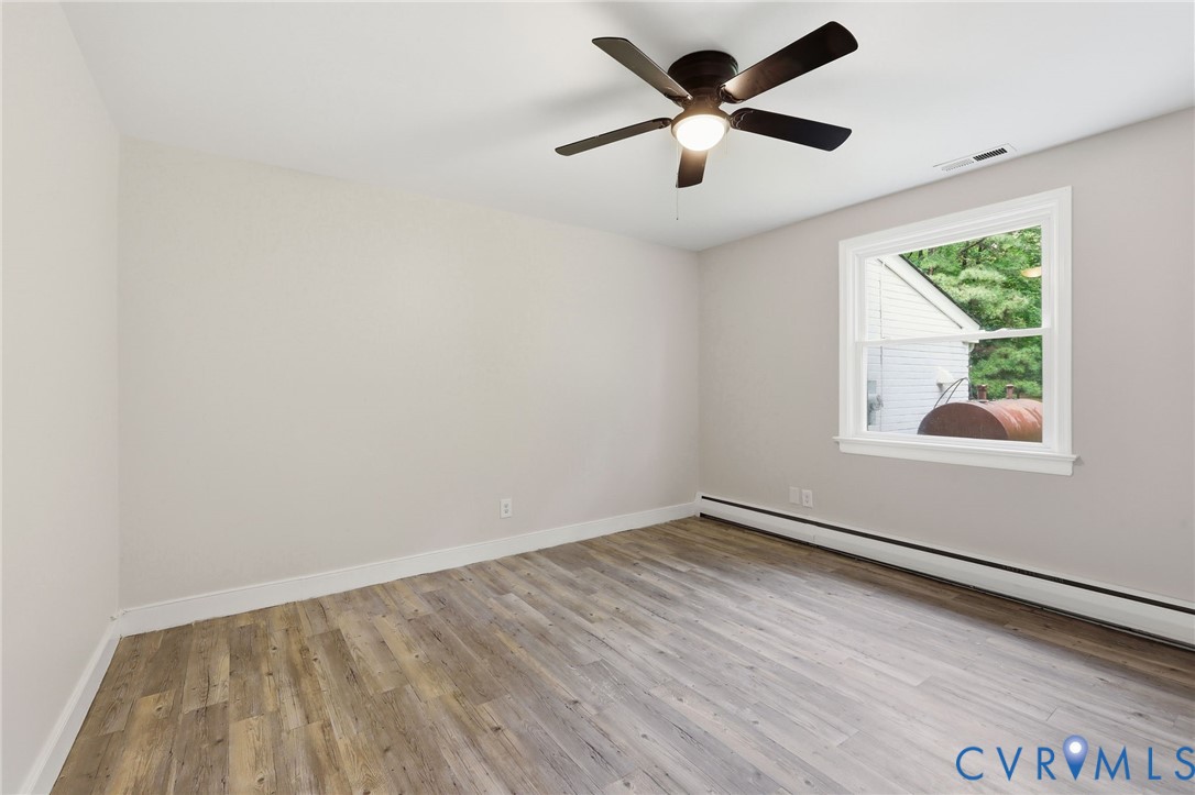 10152 Georgetown Road Mechanicsville, VA 23116 - Photo 17 of 35 an empty room with a window and a ceiling fan