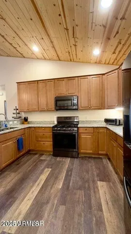 a kitchen with a stove sink and cabinets