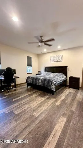 a spacious bedroom with a bed and window
