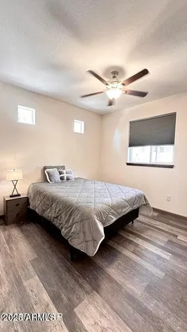 a bedroom with a bed and a ceiling fan