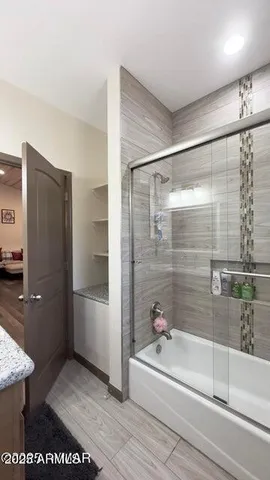 a bathroom with a shower and a bath tub