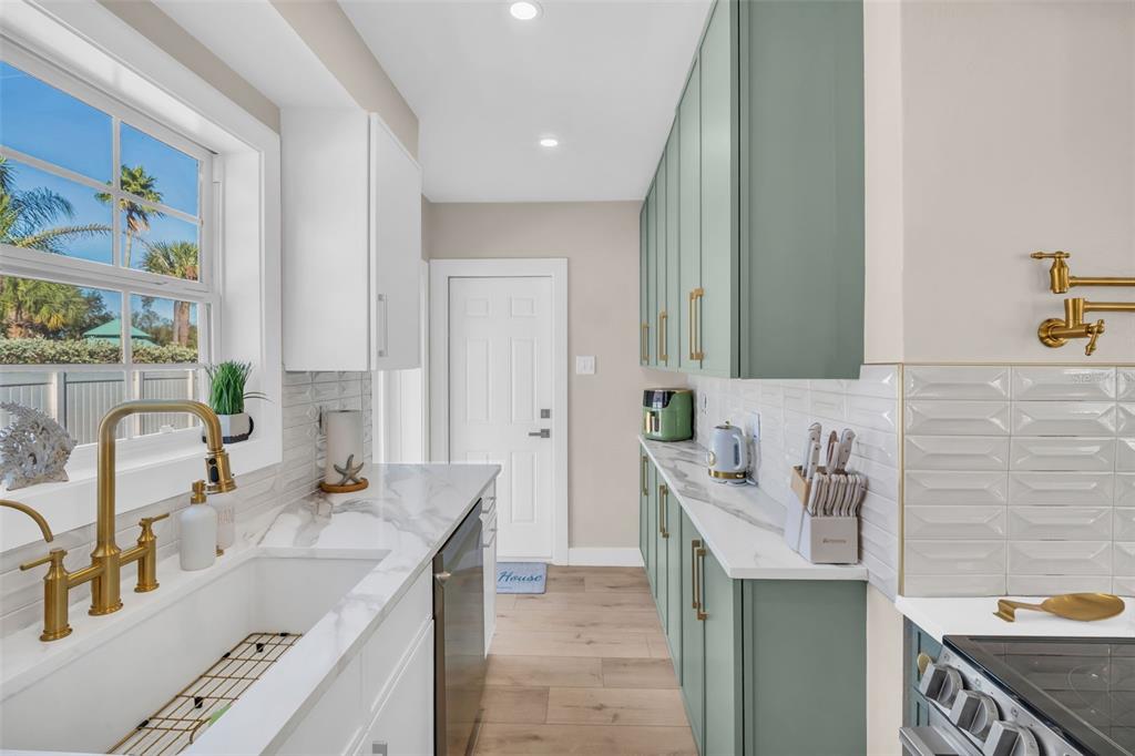 16613 Gulf Boulevard North Redington Beach, FL 33708 - Photo 14 of 51 a bathroom with a granite countertop double vanity sink and a mirror