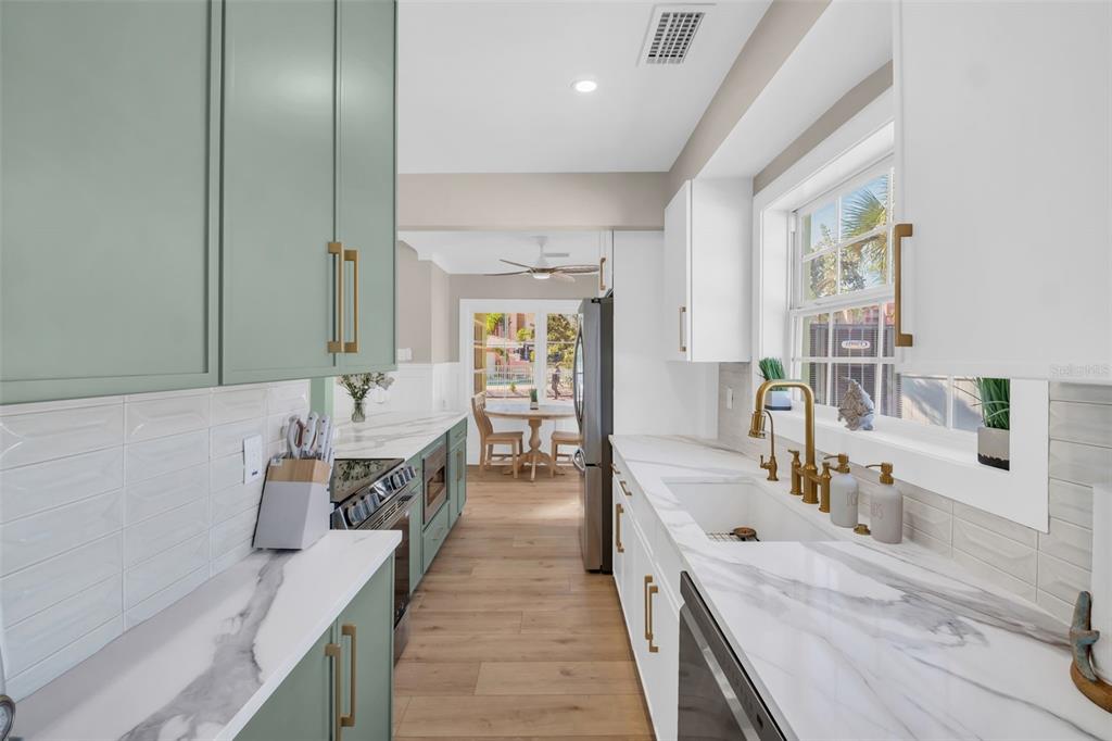 16613 Gulf Boulevard North Redington Beach, FL 33708 - Photo 15 of 51 a large white kitchen with a large window and stainless steel appliances