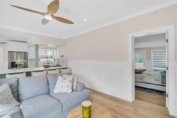 a living room with furniture and a view of bedroom