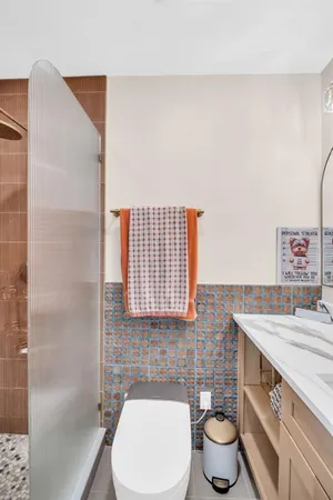 a bathroom with a sink toilet and shower