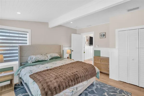a bedroom with a bed and a dresser