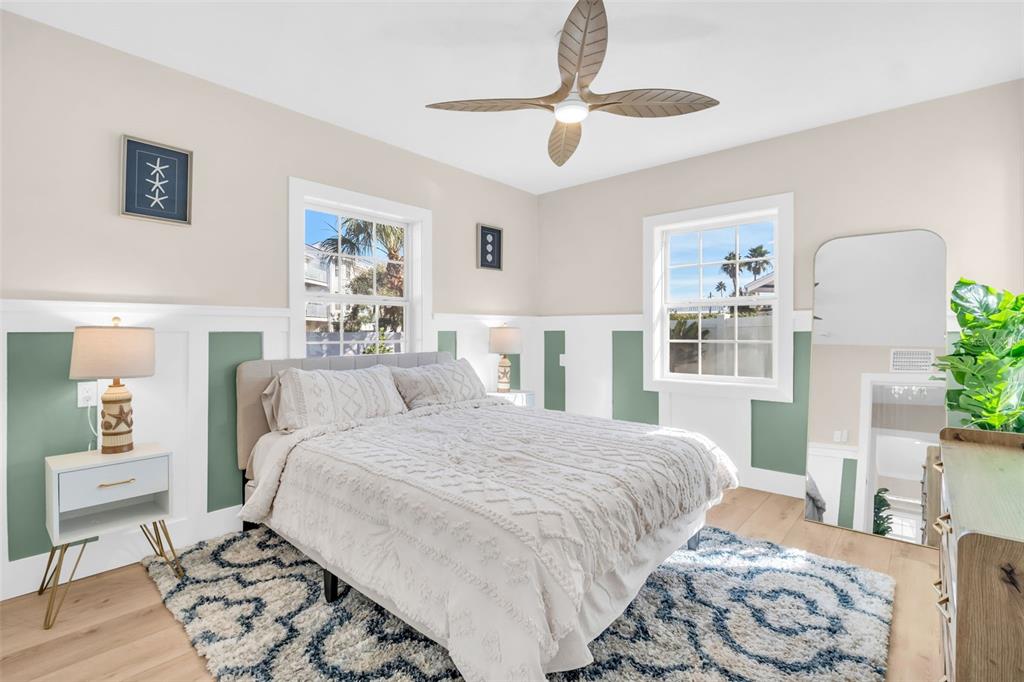 16613 Gulf Boulevard North Redington Beach, FL 33708 - Photo 28 of 51 a bedroom with a large bed and a chandelier