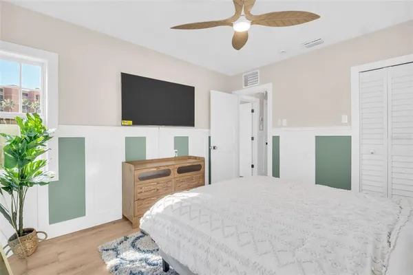 a bedroom with a bed and a flat screen tv