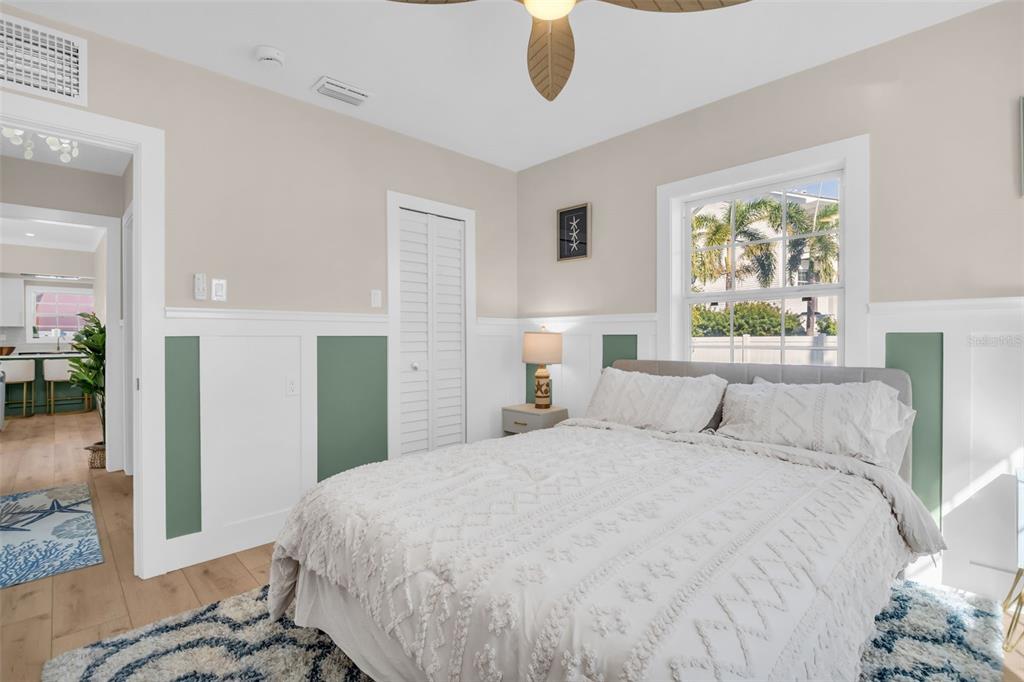 16613 Gulf Boulevard North Redington Beach, FL 33708 - Photo 30 of 51 a bedroom with a large bed and a chandelier