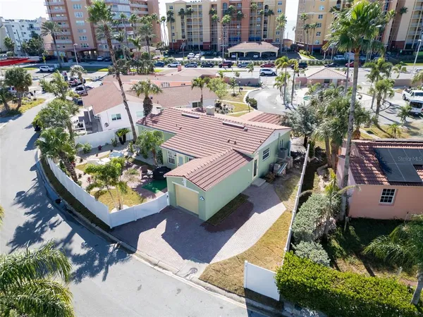 an aerial view of a house with swimming pool and outdoor seating