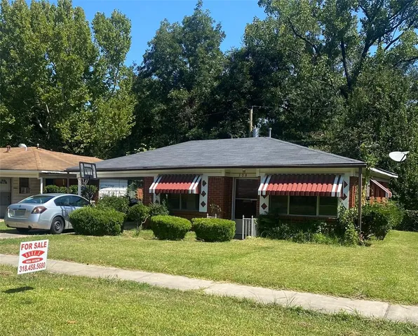a front view of house with yard and green space