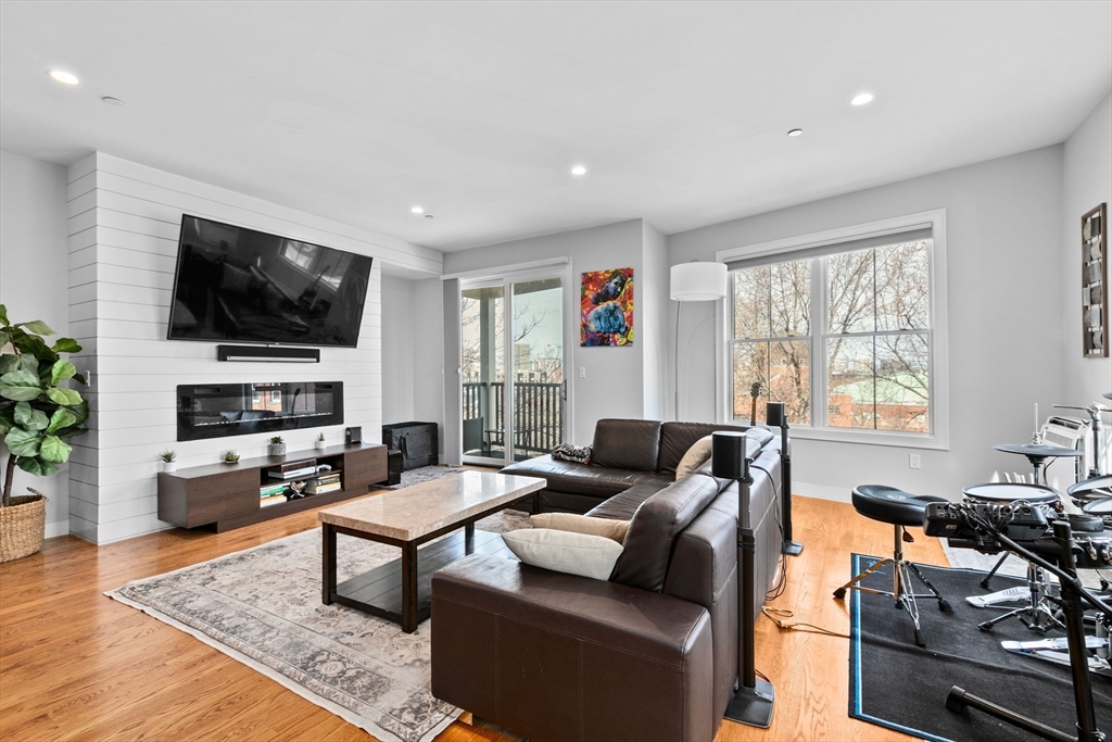 17 Centre Street, Unit 2 Boston, MA 02119 - Photo 12 of 34 a living room with furniture and a flat screen tv
