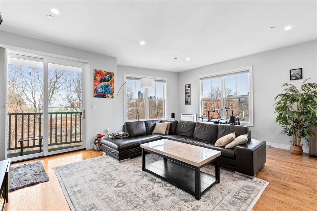 17 Centre Street, Unit 2 Boston, MA 02119 - Photo 13 of 34 a living room with furniture and a rug