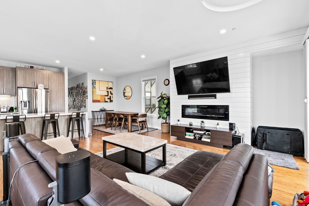 17 Centre Street, Unit 2 Boston, MA 02119 - Photo 15 of 34 a living room with furniture and a flat screen tv