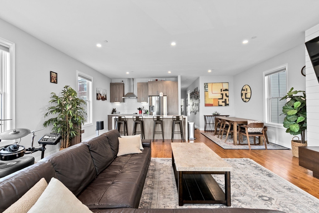 17 Centre Street, Unit 2 Boston, MA 02119 - Photo 16 of 34 a living room with furniture kitchen view and a potted plant