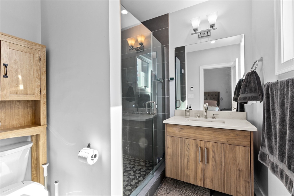 17 Centre Street, Unit 2 Boston, MA 02119 - Photo 18 of 34 a bathroom with a double vanity sink and a mirror