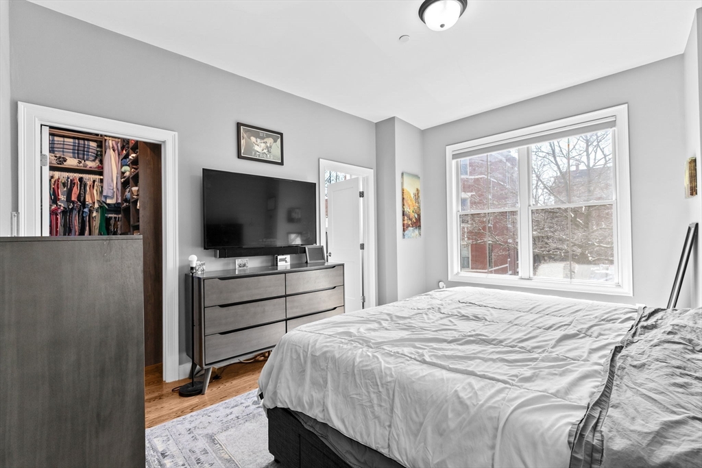 17 Centre Street, Unit 2 Boston, MA 02119 - Photo 21 of 34 a bedroom with a bed and a flat screen tv