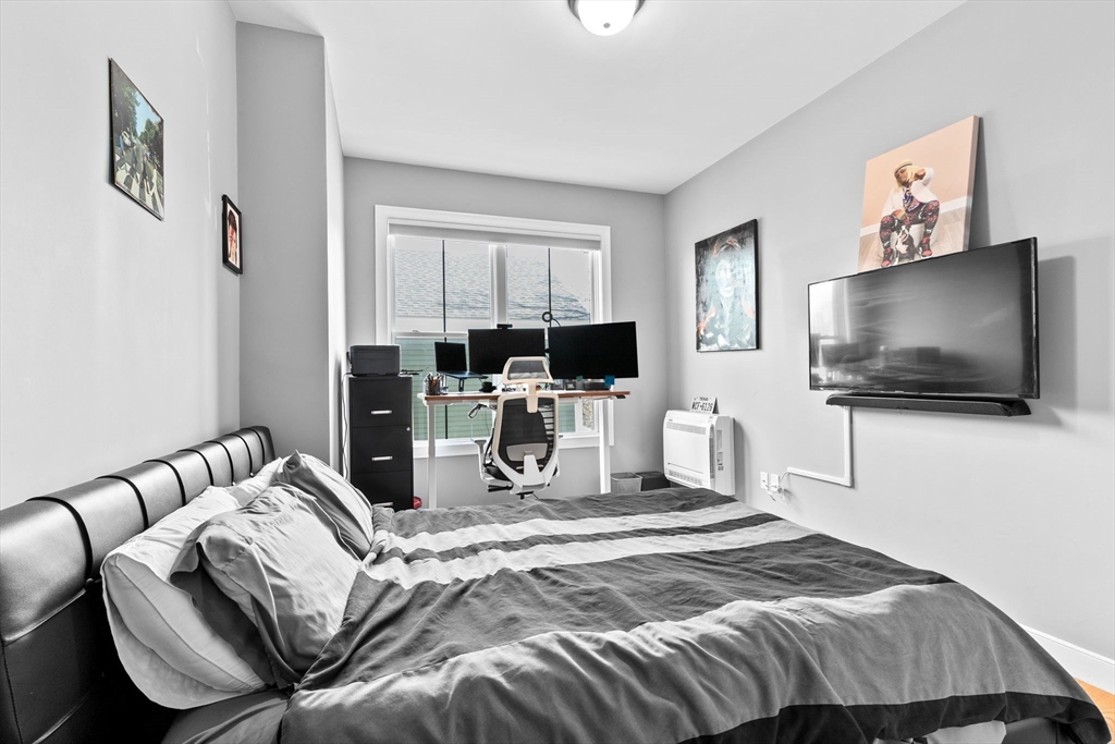 17 Centre Street, Unit 2 Boston, MA 02119 - Photo 24 of 34 a bedroom with a bed and a flat screen tv
