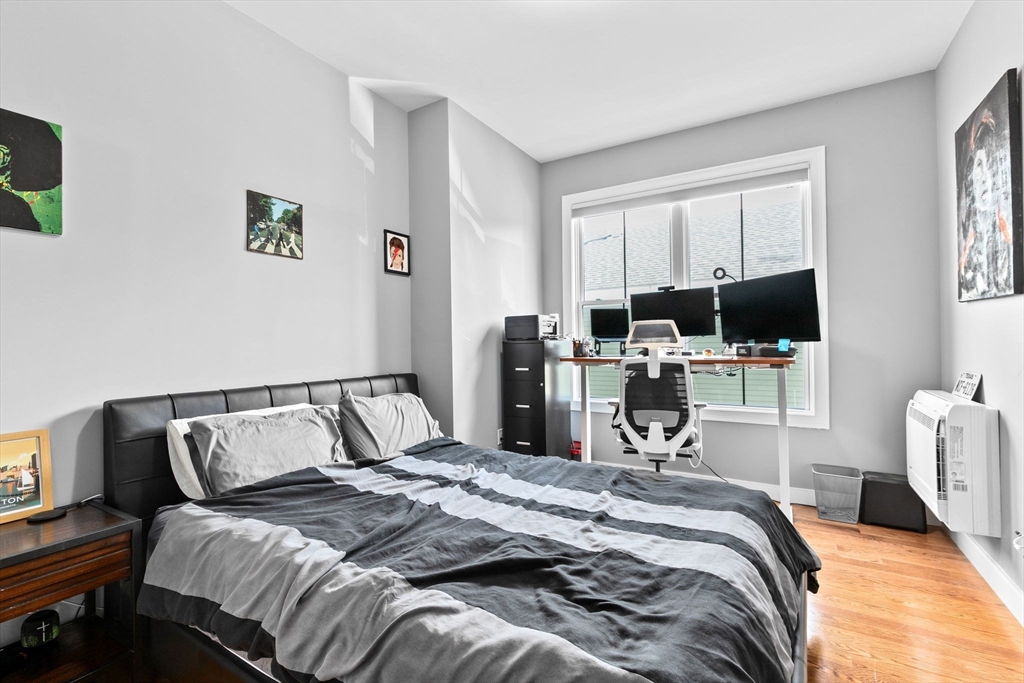 17 Centre Street, Unit 2 Boston, MA 02119 - Photo 27 of 34 a bedroom with a bed and a flat screen tv