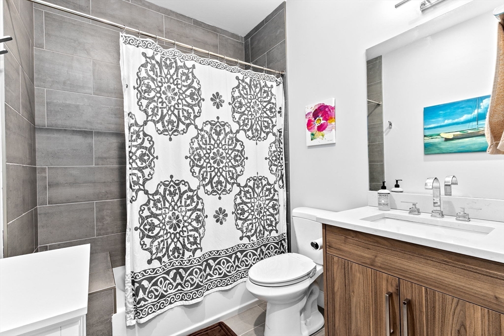 17 Centre Street, Unit 2 Boston, MA 02119 - Photo 28 of 34 a bathroom with a sink toilet and shower