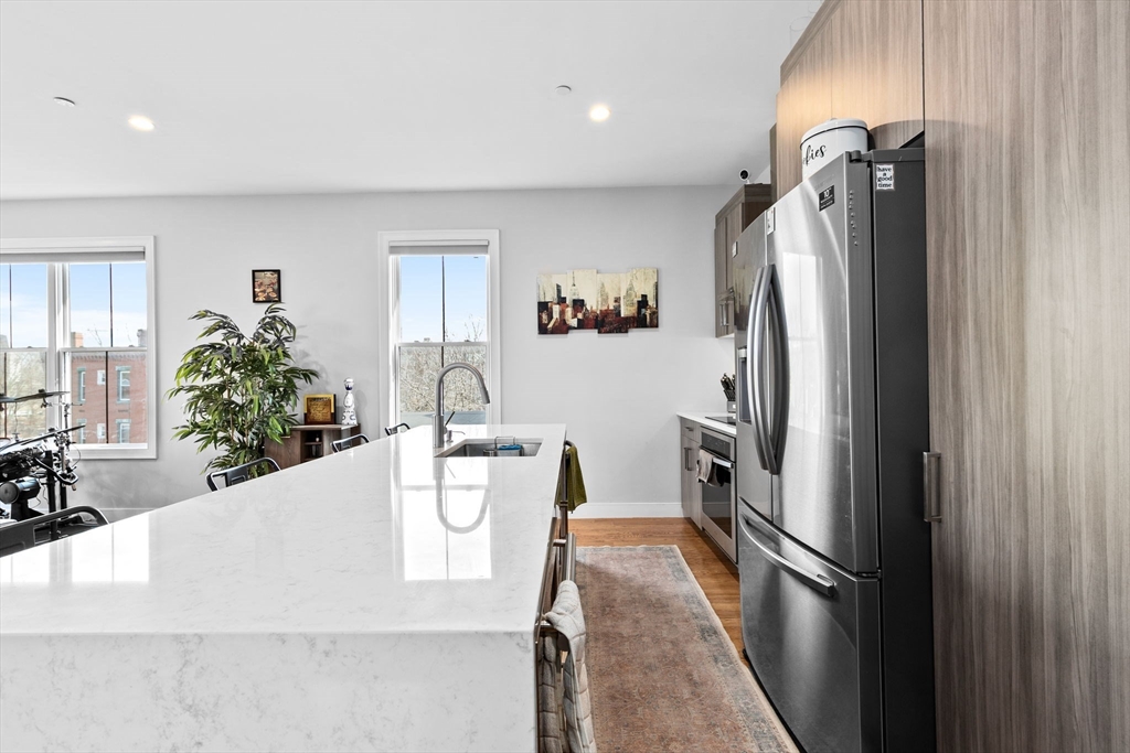 17 Centre Street, Unit 2 Boston, MA 02119 - Photo 6 of 34 a kitchen with stainless steel appliances granite countertop a refrigerator and a sink
